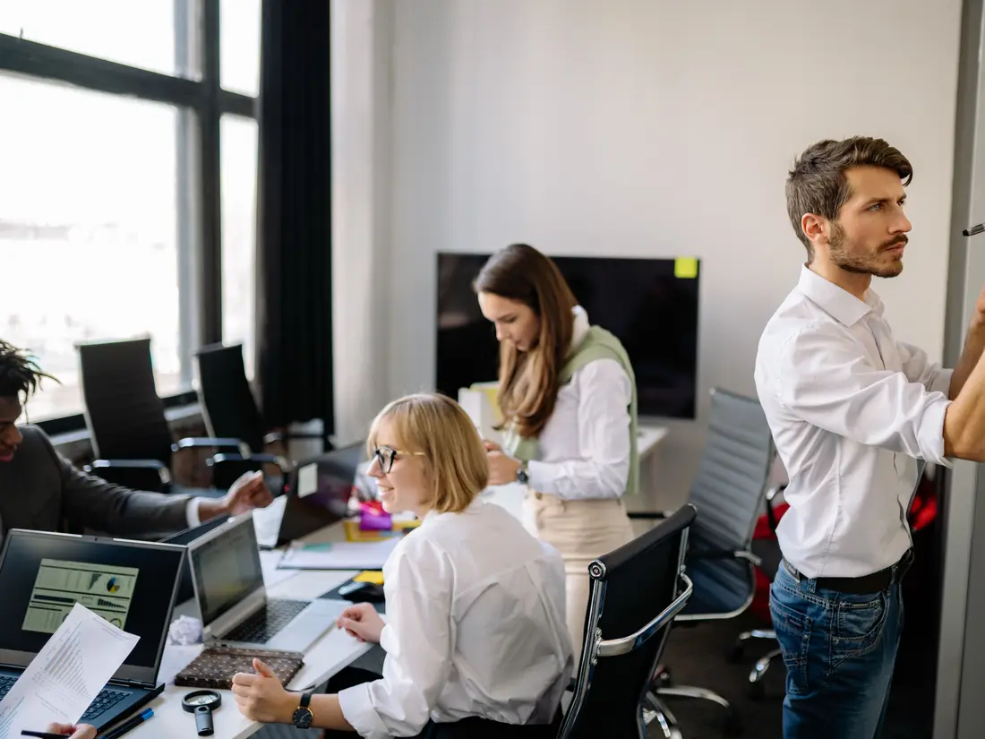 Staff working at desks with monitors in an open-plan office