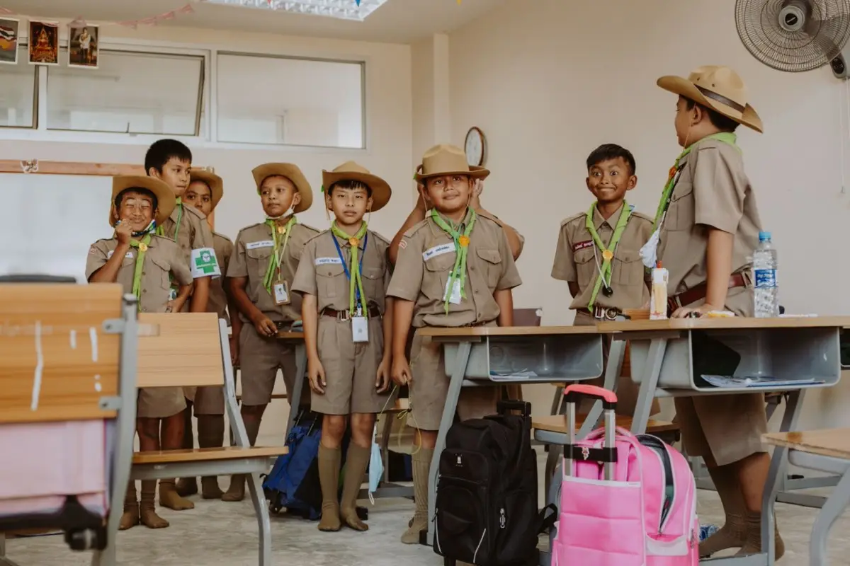 Schoolchildren in uniform standing together in a classroom